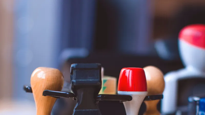 Rubber stamps with wooden, black and red handles on a stand